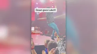 Luke Bryan slips on cell phone thrown on stage by fan