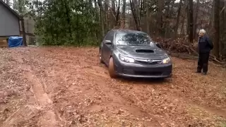 Subaru WRX STI pulling a BMW out of mud.