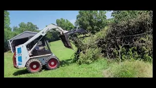 moving stuff with a Ottawa grapple with a 743 Bobcat