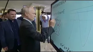 Vladimir Putin draws an unusual smiley face on an electric whiteboard in Moscow