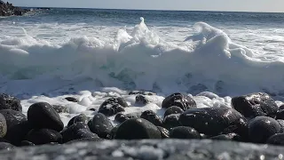 Waves crashing onto pebble beach . same beach as seen on crossfire.