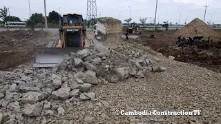 Excellent Incredible Bulldozer SHANTUI firmly pushing stone rock with a 5 Ton Truck Spreading Stone