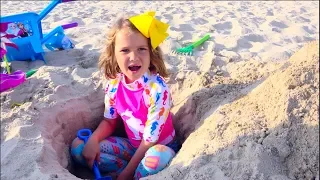 Max and Katy Playing on the beach with Daddy