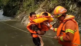 Firefighters rescue 34 tourists stranded by mountain torrents in central China