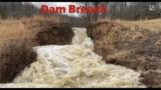 Large pond dam breach causes water surge down stream