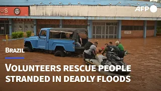 Brazilian volunteers rush to rescue people stranded by deadly floods | AFP