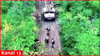 Russians hiding in the forest surrender to Ukrainian soldiers arriving in an armored vehicle