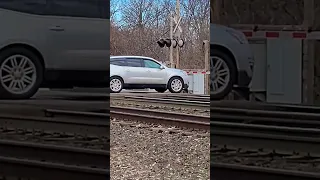 80 MPH Amtrak speeds through crossing seconds after a genius driver goes around gates!! 02/19/2023