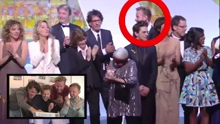 Guy walks on stage with winners Palm d'Or Award @ Cannes Film Festival 2015