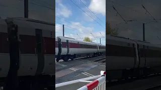 LNER azuma and slow class 66 at Helpston level crossing