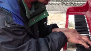 Homeless man on the street plays beautifully