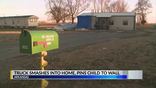 Truck pins child to wall