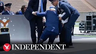 Watch Biden trip and fall on stage at Air Force graduation ceremony