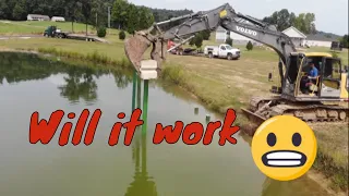 Redneck pile Driving installing steel piers for a new Dock with excavator and large weight