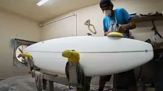 Sanding a board at Clay’s place.