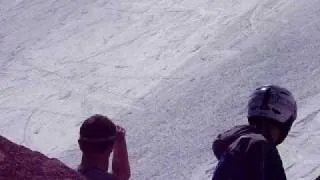 Tucks skier triggers avalanche then bites it.
