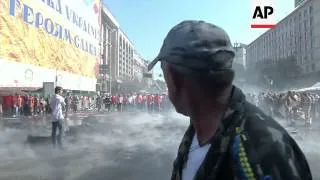 Demonstrators confront city workers attempting to clear Independence Square, setting tyres on fire