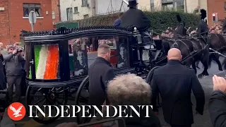 Thousands line streets as Shane MacGowan's funeral procession travels through Dublin