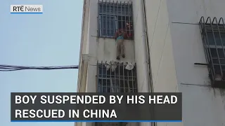 Boy dangling by his head from fifth floor window guard rescued in China