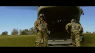 Members of the MCOE Fort Rucker Detachment Band flying in a Chinook