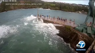 Child nearly swept away by high tide while playing on pier in England