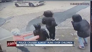 Police car almost slams into children and it's caught on camera