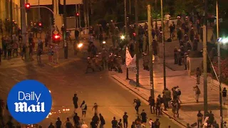 Petrol bombs fly as clashes erupt in Athens over bailout - Daily Mail