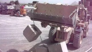 US Army JCB HMEE I in action in Afghanistan moving concrete peirs.