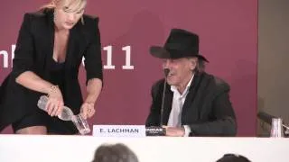 Kate Winslet helps her colleague at a press conference