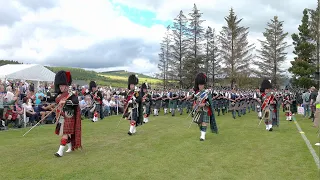 Drum Majors lead Massed Pipe Bands parade during  2022 Dufftown Highland Games in Moray Scotland