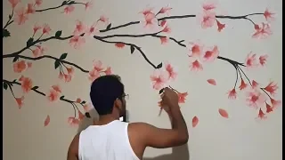 Painting flowering branch (cherry) on the living room wall