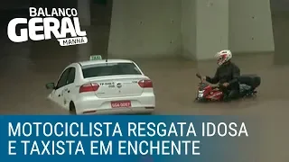 Motociclista resgata idosa e taxista presos na enchente em SP