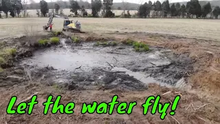 Draining a pond with Volvo Excavator and clearing trees off the dam in perception to be filled in