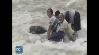 Firefighters brave rapids to rescue people caught in flood