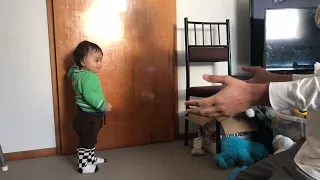 Baby’s first steps and father’s priceless reaction.