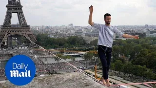 Barefoot rope walker tightropes from the Eiffel Tower