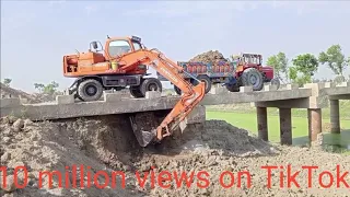 Excavator's strong arm:pulling open new pull roof with Ease;