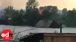 Entire houses washed away by floods in Russia