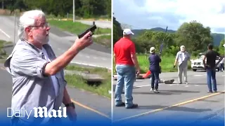 Shocking moment motorist shoots dead two environmental protesters blocking a road