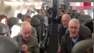 Incredible moment furious plane passengers are cheered up when pensioners start singing