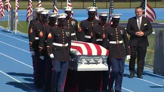 Solemn march as fallen Marine brought to service