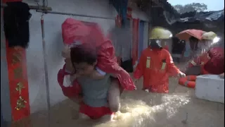 Firefighters Evacuate Trapped Residents in Flooded South China Towns