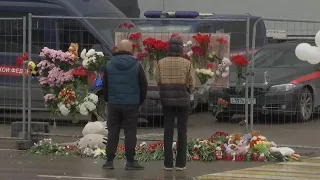 Survivor describes ordeal, mourners lay flowers at Moscow concert hall after terror attack