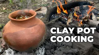 Cooking Stew in a Clay Pot on a Campfire