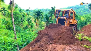 Extreme!! The D6R XL Bulldozer forms a new road by cutting a hillside at the edge of a ravine