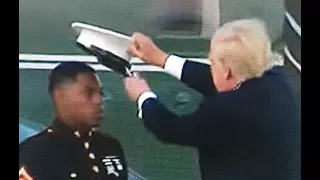 PRESIDENT TRUMP PUTS MARINE'S HAT BACK ON AFTER WIND BLOWS IT AWAY