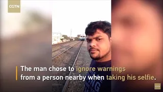 Shocking footage shows Indian man getting hit by a train while trying to take a selfie..