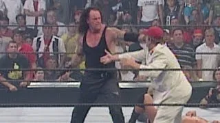 Disguised as a WWE fan, "Cowboy" Bob Orton helps his son Randy Orton defeat The Undertaker