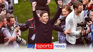 Fans celebrate after Bayer Leverkusen are crowned Bundesliga champions for the first time in history