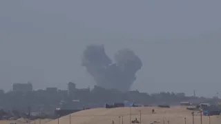 Explosions and plumes of smoke visible from Muwasi in the direction of Rafah